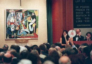 An unidentified person holding numbered paddle makes a bid on Pablo Picasso's painting, "Les femmes d'Alger" 10 November in New York at Christie's auction house. The painting sold for 31.9 million USD and was one of 58 pieces of 20th century art offered for sale from the collection of Victor and Sally Ganz. At right, Christie's employees take telephone bids. AFP PHOTO/Stan HONDA        (Photo credit should read STAN HONDA/AFP/Getty Images)